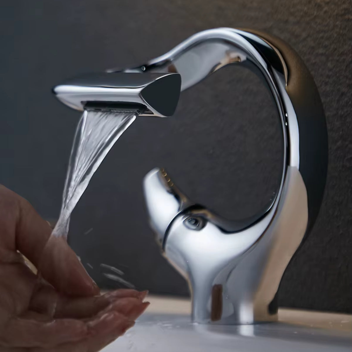 Main placée sous l'écoulement en cascade du robinet de lavabo NORVA chromé